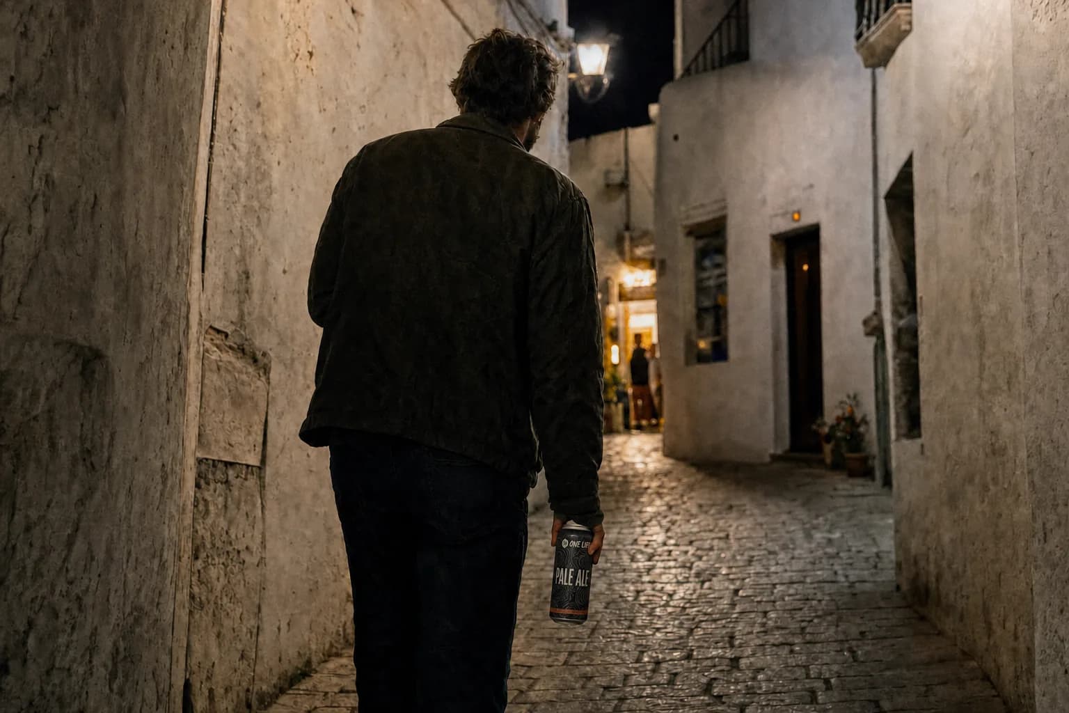 Render of a figure walking a whitewashed old town street at night carrying a One Life Pale Ale can
